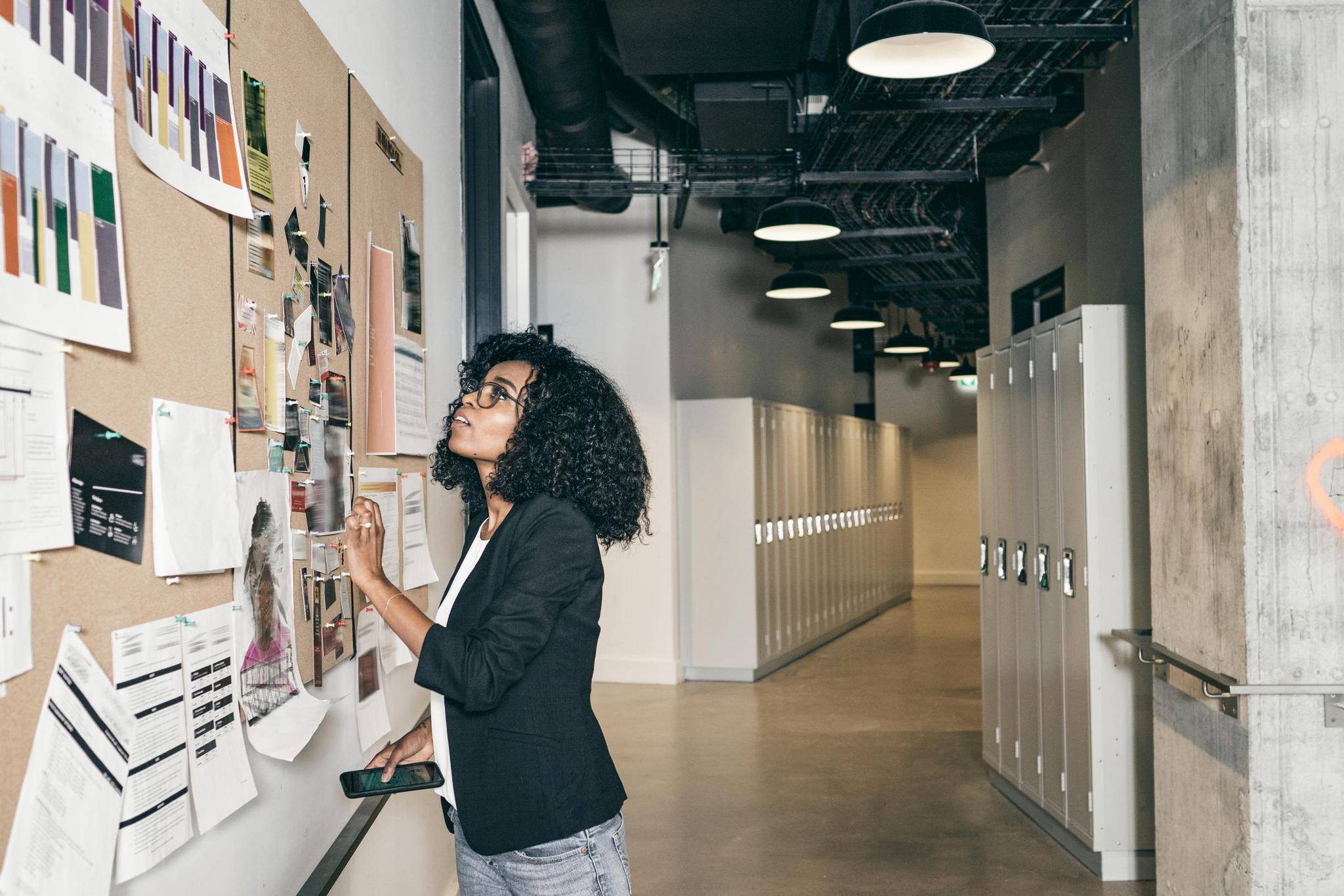 School board member reviews training schedule on school bulletin board