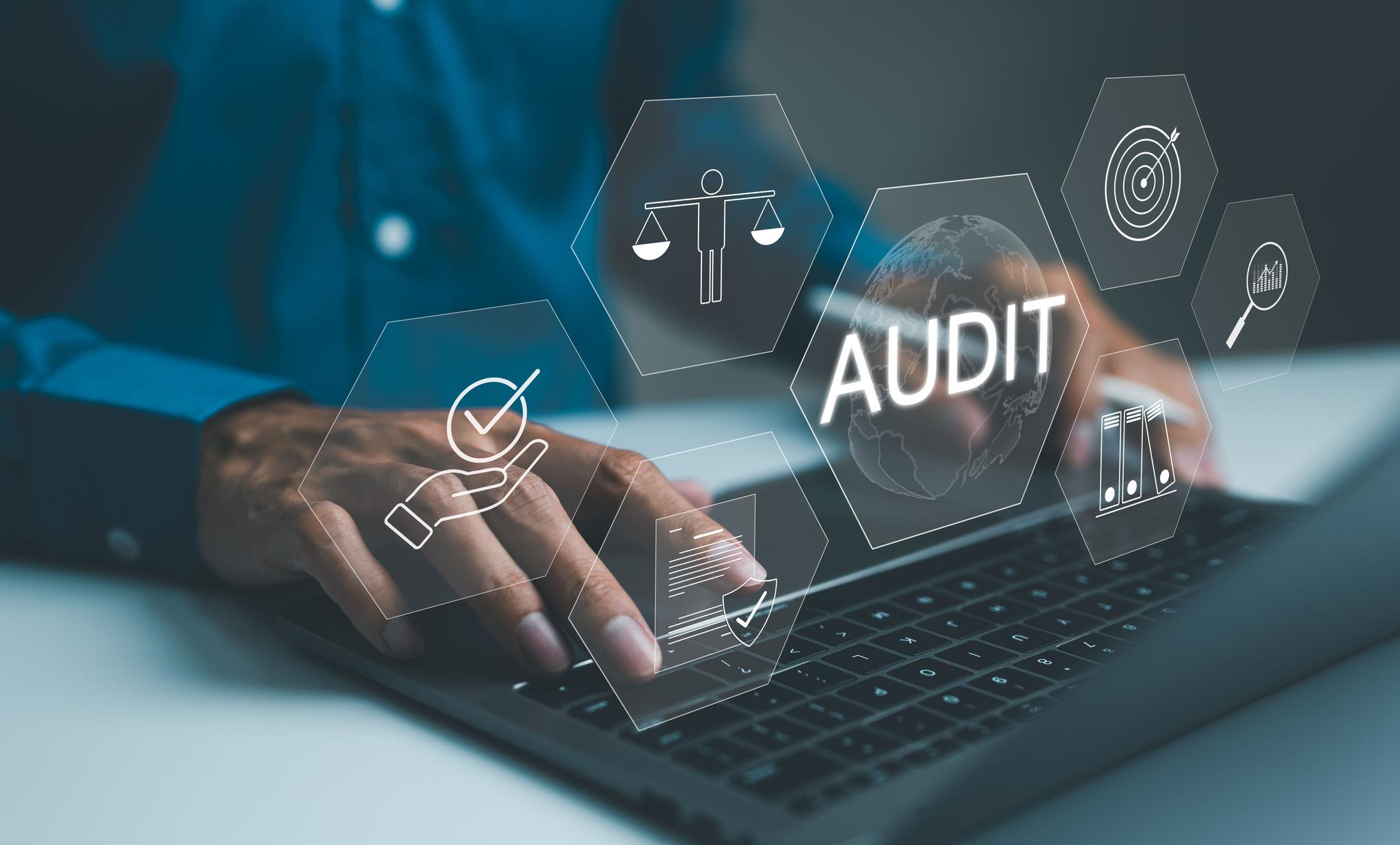 Professional conducting a business audit using laptop with virtual interface displaying audit, and compliance data analysis icons. Evaluation financial, standard certification